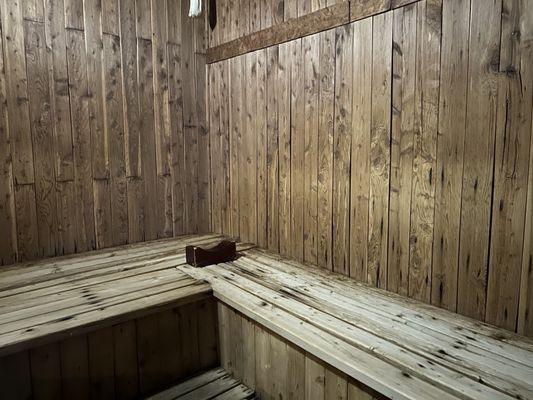 Dry sauna with wooden pillows for relaxation.