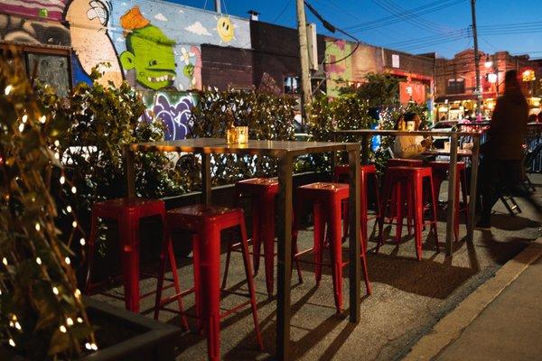 Outdoor dining area, complete with high tops to accommodate small groups.