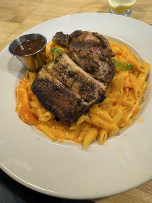 Jerk chicken pasta with barbecue sauce on the side