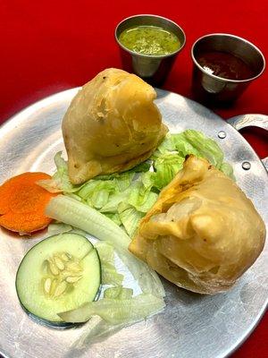 Vegetable Samosa - Fried crispy pastry stuffed with delicately spiced potatoes and peas.