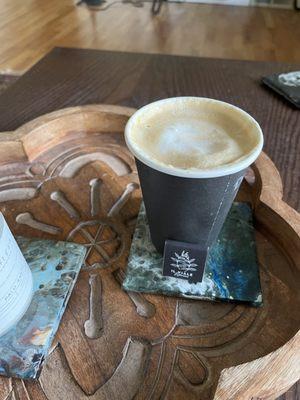 Took this one at home. Pictured here is a 12 oz cafe latte. The baristas always serve up a square of chocolate with each drink order.