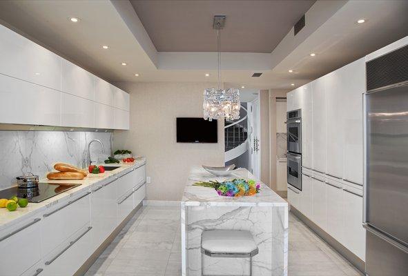 High gloss Pedini cabinets. White Statuary marble. NYC view...