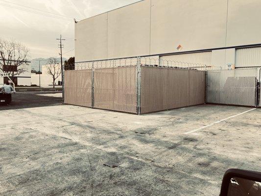 industrial 8' high chain link fence with beige slats