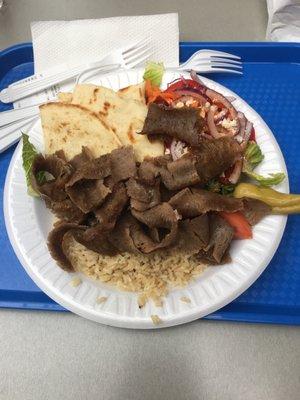 Gyro platter with brown rice, white pita.