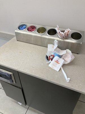 Dunkin saddle brook nj Overflowing garbage and dirty counter.