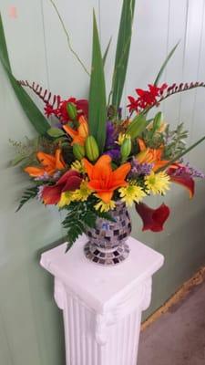 Beautiful unique floral design in keepsake container. Great gift to brighten someone's day.