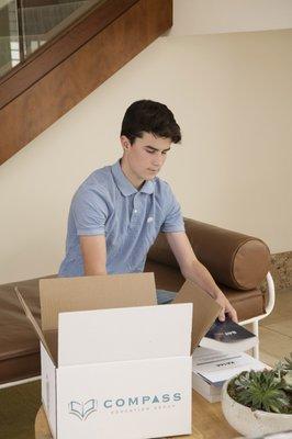 A student opening their materials package