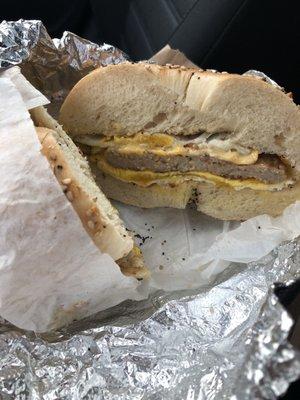 Sausage, eggs, and cheese on an everything bagel