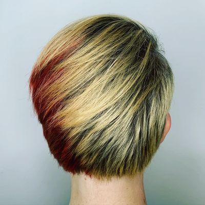 Fashion color finished with a heavily textured short women's haircut that can be worn to either side.