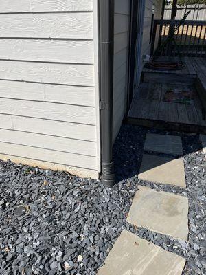 Downspout repair, paver installation and created walkway feature to rebury pipe and upgrade damaged landscape area