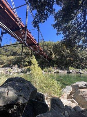 Shaded area under the bridge near the river