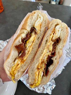 Bacon egg and cheese with hot sauce on a roll