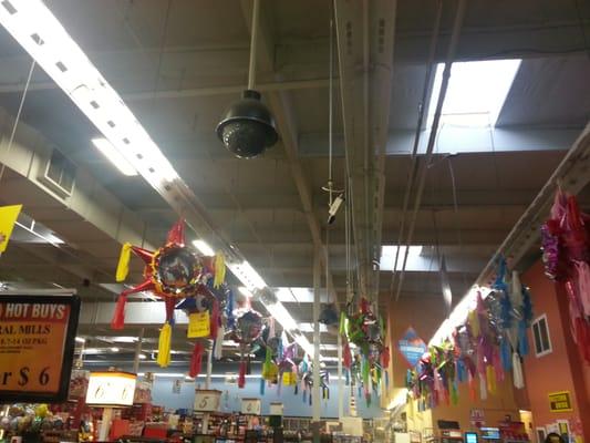 PTZ camera extended from ceiling in a grocery store