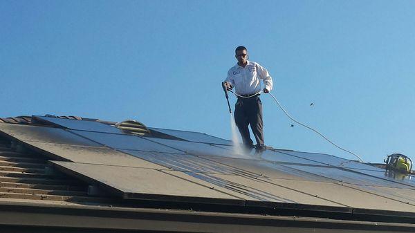 Power washing pigeon dropping off solar panels and roof.