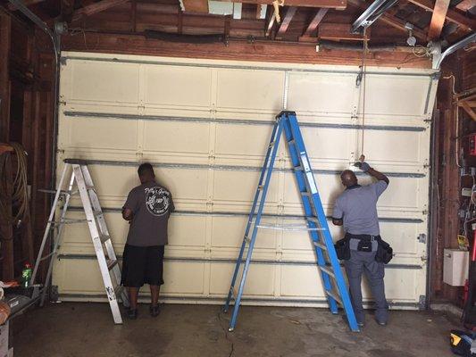 Taking down the old door.