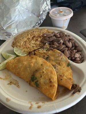 Crispy Birria tacos with cheese, rice & beans, and consome on the side to dip the tacos in.