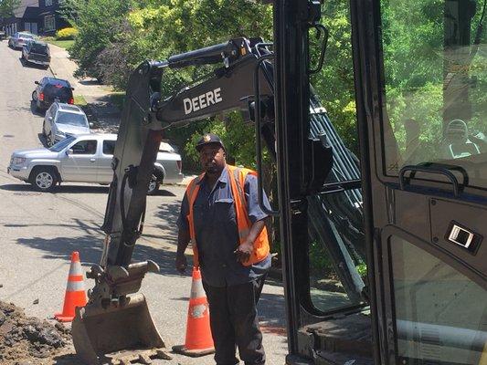 Isiah getting ready to excavate in the city street.