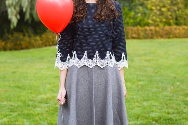 Tailored crop top with lace trim worn with grey flare skirt