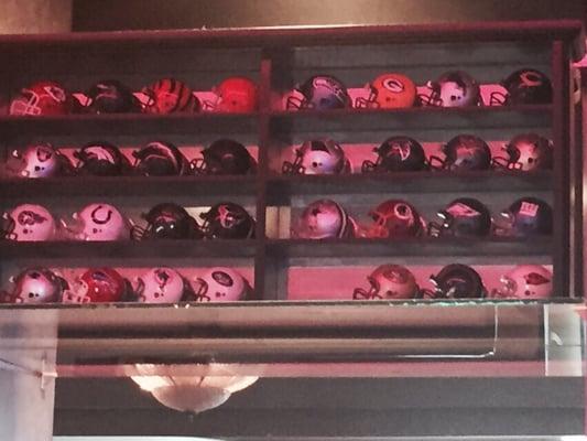 NFL helmets on display. One team missing. Come by and try to find out which one it is.