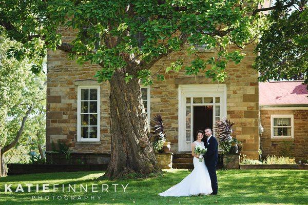 A beautiful wedding couple outside of the Stone House.