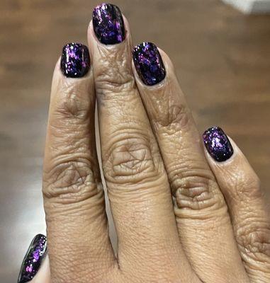 Basic black polish with iridescent flakes that change color once UV is applied. Birthday Nails extreme. By Holly