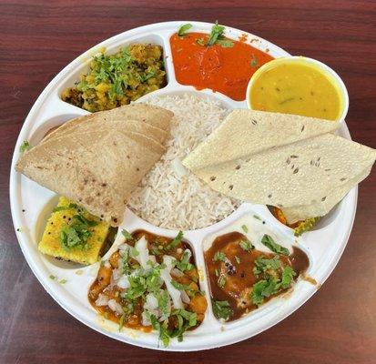 Veg Thali - dahi vada, dhokla, chana masala, undhiyo, paneer butter masala, dal, chapati