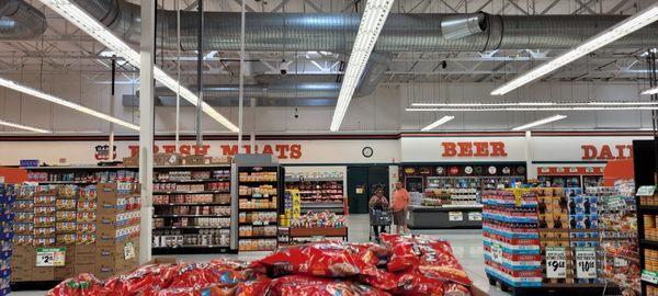 The back wall. Fresh Meats at left. Beer and Dairy at right. The Seafood counter is on the left. Orange Juice that's on the right.