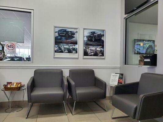 Waiting area, service. Note snacks on table. Coffee, tea, and water also available nearby.