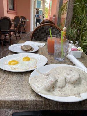 Sausage Patties, Sunny Side Up Eggs, Biscuits and Gravy, Grapefruit Juice, and Water