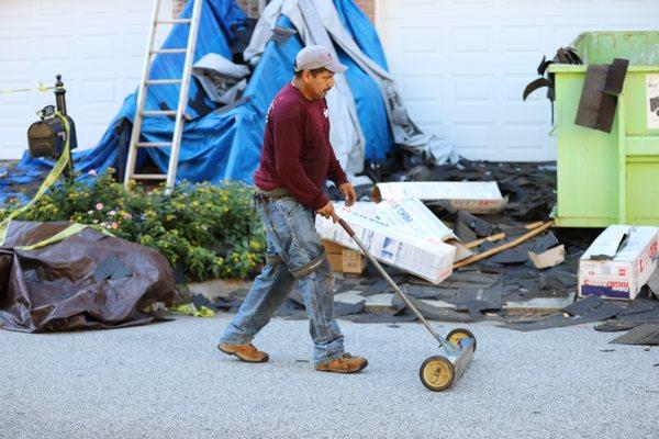 One of our technicians using a magnetic sweep to pickup all scattered nails.