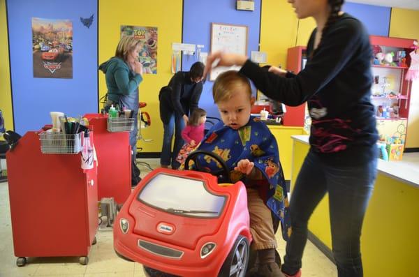 Edwin, happily in a little red car, getting his hair did!