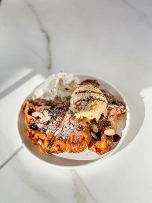 Croffles with ice-cream, whipped cream and almond slices