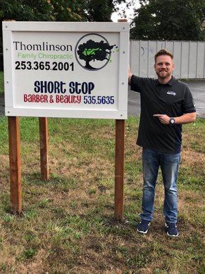 Dr. Zach next to the 1st sign that was made for the practice.