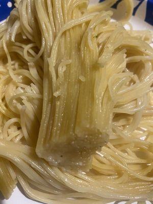 Raw capellini pasta.