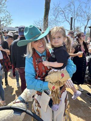 Susan, holding one of her grandchildren, after riding in the swallows day parade.