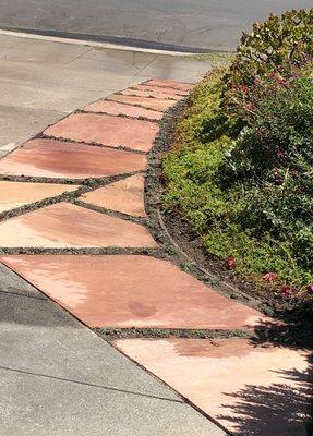 Flagstone steps next to driveway.