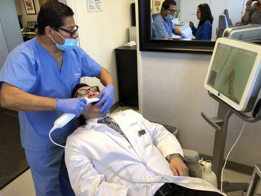 Cesar scanning Dr. Chau with the iTero scanner. No more impressions.