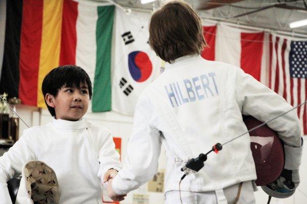 "Salute and shake hands," the conclusion of a youth bout at DC Fencers Club.