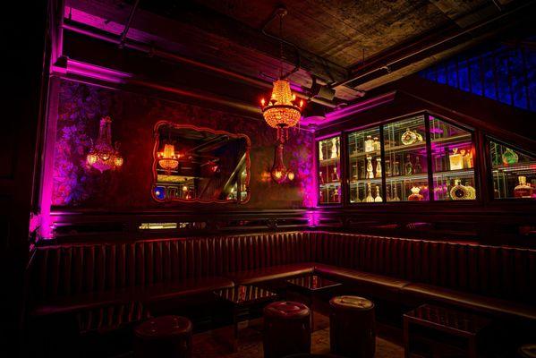 Experience a world of intrigue and charm at the speakeasy hidden beneath the Ivory Peacock Bar