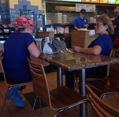 Hospital workers getting lunch across the street wearing hair and shoe covers. No longer sterile.