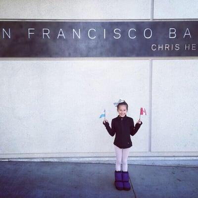 San Francisco Ballet School - Student holding flags from Argentina and Peru.  Ballet uniting all nations as one.