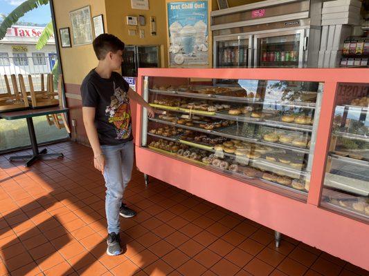 Choosing a doughnut on a Sunday afternoon