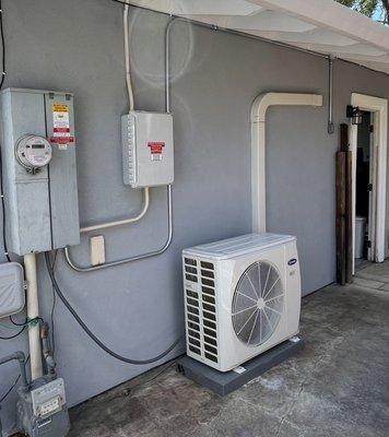 Conduit run for Tesla Wall charger install - exterior conduit with wall penetration into garage near rear door.