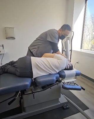 Dr. Hahn adjusting my neck before handling my lower back.