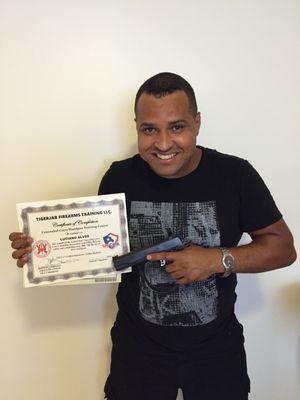 Happy student with his Basic Firearms safety class certificate