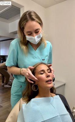 Her sweet assistant gave me a face massage before the whitening trays.