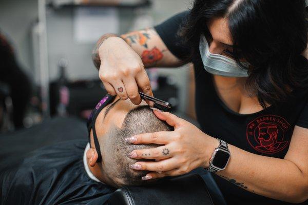 Cristina performing a straight razor line up