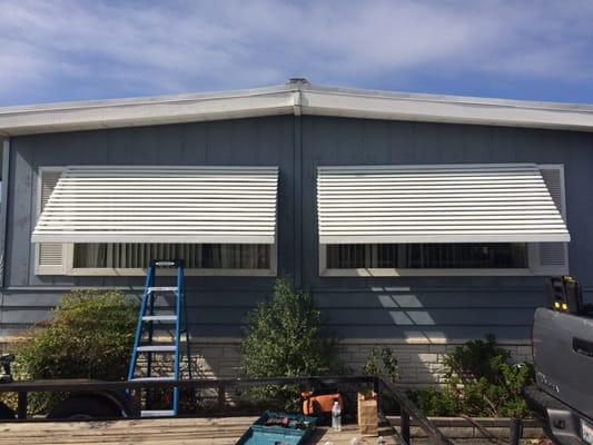 Louvered window awnings provide functional shade and a stylish look