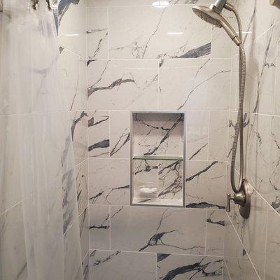 Built in shelving! Beautiful wall tiles! We love this shower!