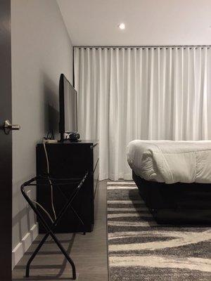 Crisp white curtains in the guest room.